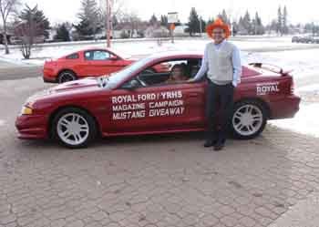 Megan Procyshen receives the keys to her new Ford Mustang from Terry Ortynsky (standing). Procyshen was the top winner in the Yorkton Regional High School&#8217;s annual magazine campaign Mustang giveaway. One of the top sellers in the school, Procyshen sold 89 magazines. She is also the second person in her family to win, as her older brother Michael won the car a few years ago. The 16 year old says she doesn&#8217;t know what she plans to do with the car yet, but she&#8217;s thrilled to be the big winner. &#8220;I&#8217;m wicked excited, I didn&#8217;t think that I was going to win it,&#8221; she closes.