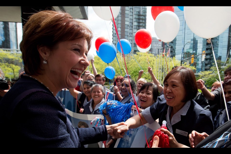 Premier Christy Clark greets staff at a Vancouver hotel as she arrives for the first meeting of newly-elected B.C. LIberal MLAs. Thursday, May 23, 2013.