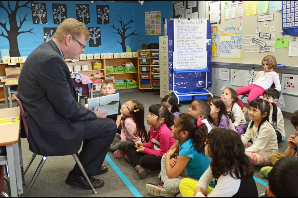 Burnaby school district superintendent Kevin Kaardal reads to a class of South Slope Elementary students during the school's literacy week.