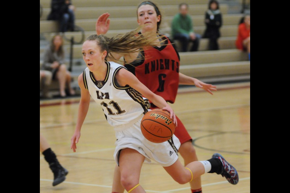 Little Flower Academy guard Jessica Hanson blows past a defender in a league game at LFA on Feb. 3, 2015. Photo Dan Toulgoet