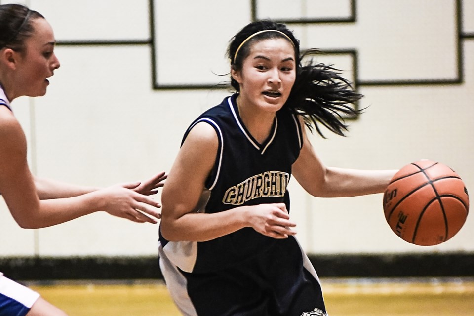 Churchill Bulldog guard Katrina Kwong (No. 10) stays out of reach of her McMath defender during a senior girls AAA Lower Mainland semi-final at New Westminster secondary Feb. 20, 2015. The Bulldogs lost 67-36. Photo Rebecca Blissett