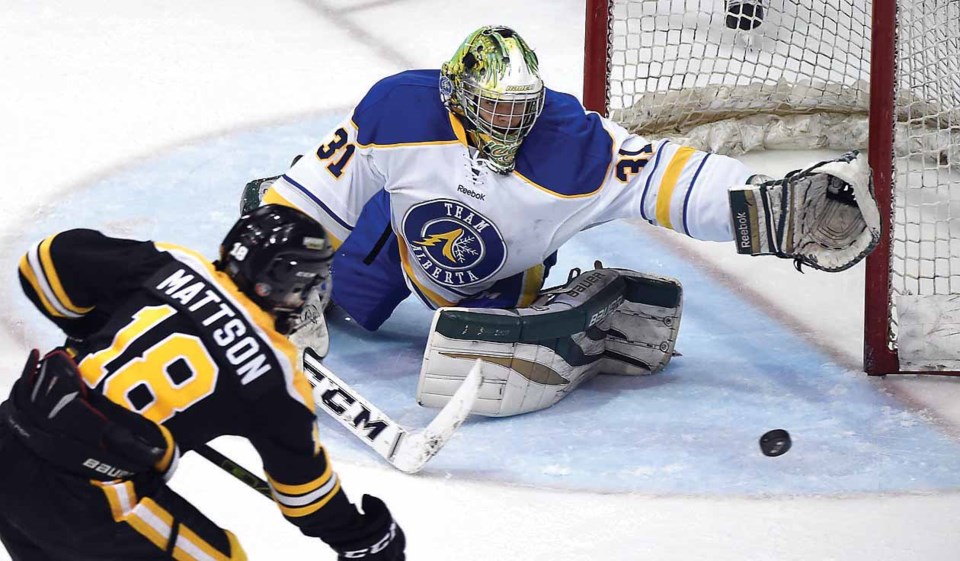 Team Manitoba’s Leif Mattson tries to pick the corner on Alberta goalie Ian Scott during the second