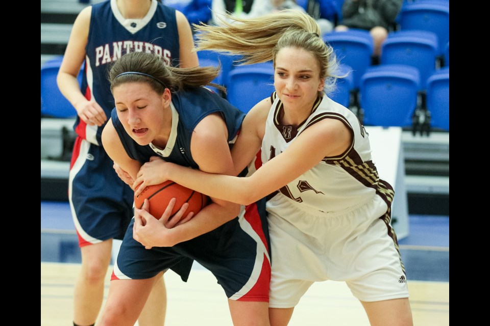 Little Flower Academy’s Alessia Risi (No. 14) fights for the basketball in a 74-61 win over the Vernon Panthers in their opening game of the B.C. Championships in Langley March 4, 2015. Photo Ron Hole