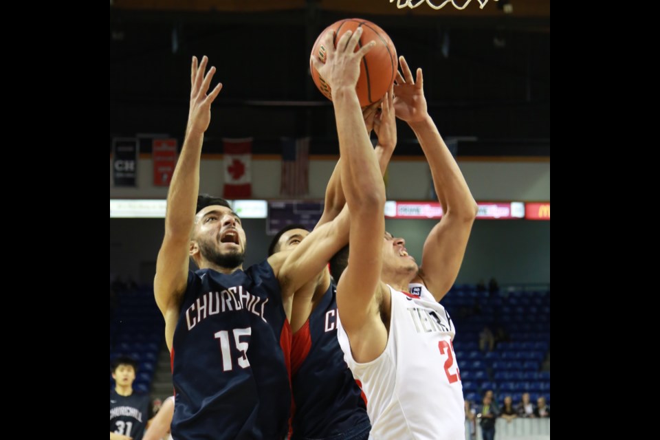 Amit Sekhon (No. 15) battles for a rebound in a 70-68 semi-final loss to the Terry Fox Ravens in the senior boys AAAA B.C. championship tournament in Langley on March 13, 2015. Photo Paul Czene