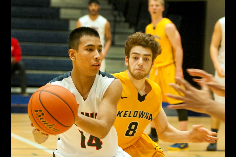 Churchill Bulldog and first-team all-star Lambert Pajayon (No. 14) looks for an opening a 100-79 loss to the Kelowna Owls in the third-place game at the senior boys AAAA B.C. championship at the Langley Events Centre March 14, 2015. Photo Chung Chow