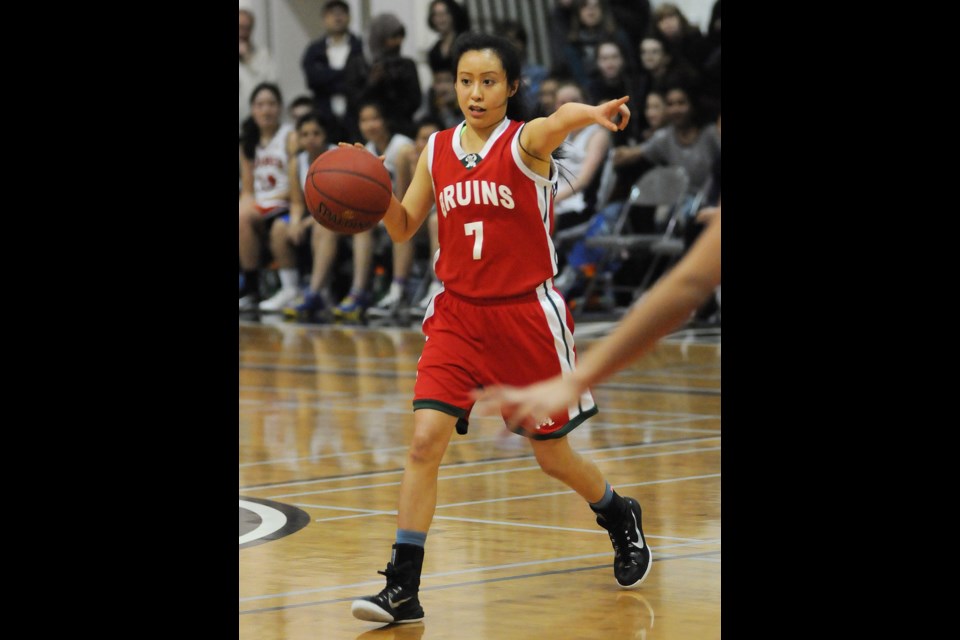 Britannia’s Jeanne d’Arc Le (No. 7) directs traffic for the Away side in the senior girls all-star basketball game at Langara College on March 27, 2015. Photo Dan Toulgoet