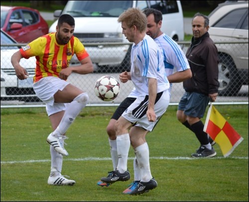 Temple's Taran Bir fights for the ball against a pair of Whistler players during the HSMSL title game on Saturday.