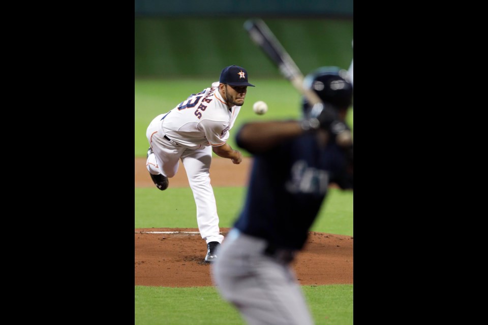 Houston Astros' Lance McCullers, left, delivers a pitch to Seattle Mariners' Austin Jackson in the first inning of Sunday's game in Houston.