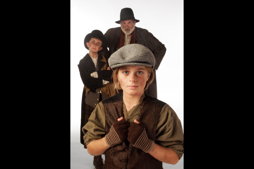 Carly Ronning, in foreground, stars as Oliver in Theatre Under the Stars Oliver, with Nathan Piasecki (rear, left) as the Artful Dodger and Stephen Aberle as Fagin.