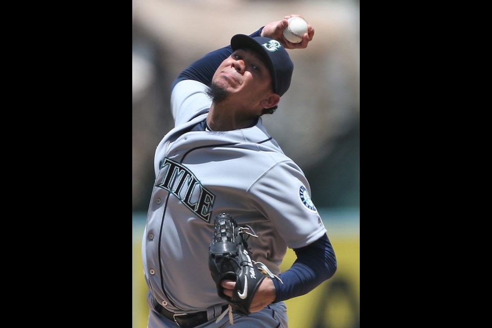 Seattle Mariners pitcher Felix Hernandez delivers a pitch during the sixth inning on Sunday at Angel Stadium in Anaheim, Calif. He had a one-hit shutout going, but was replaced in the next inning due to an injury.