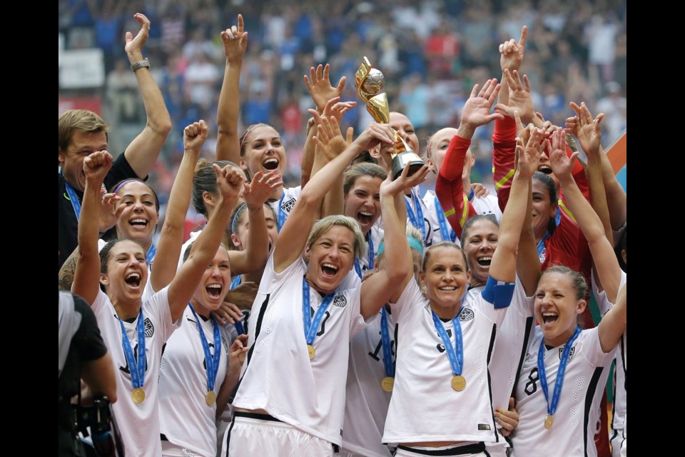 The United States Women's National Team celebrates with the trophy after they beat Japan 5-2 in the FIFA Women's World Cup soccer championship in Vancouver on Sunday.