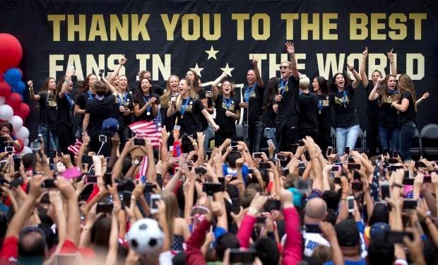 Members of the U.S. women's soccer team and fans celebrate the team's World Cup championship during a public celebration, Tuesday, July 7, 2015, in Los Angeles. This was the first U.S. stop for the team since beating Japan in the Women's World Cup final Sunday in saʴý. (AP Photo/Jae C. Hong)