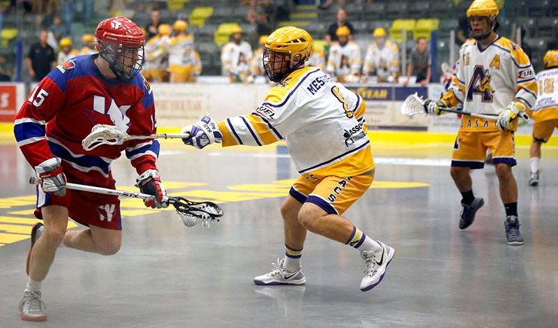 Coquitlam Adanacs captain Michael Messenger defends against New Westminster forward.