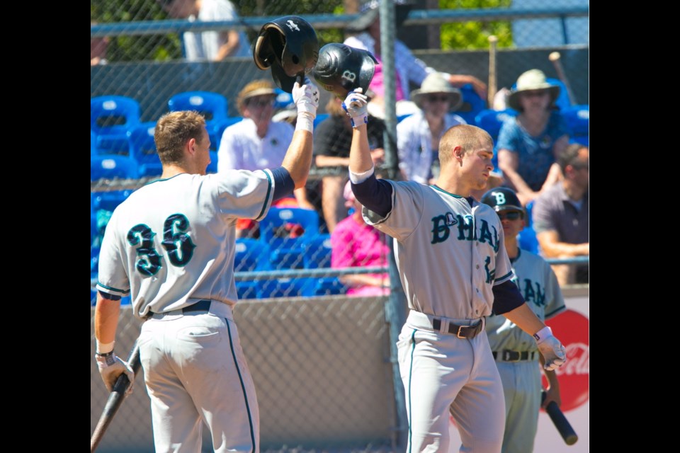 Saturday: Bellingham Bulls Dustin Branton, right, celebrates his home run with Aaron Stroosma in West Coast League action against the Victoria HarbourCats at Royal Athletic Park.