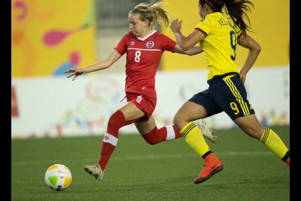 saʴý's Emma Fletcher (8) gets a chance at goal while defended by Colombia's Orianica Velasquez (9) during the first half of 2015 Pan Am Games women's semi-final soccer action in Hamilton, Ontario on Wednesday.