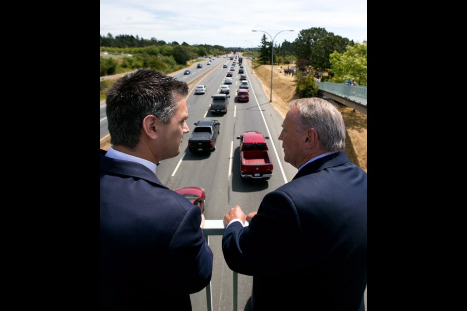 B.C. Transportation Minister Todd Stone, left, and 91ԭ Island North MP John Duncan look out over the approach to the Admirals Road/Trans-Canada Highway intersection during the projects' announcement on Wednesday.