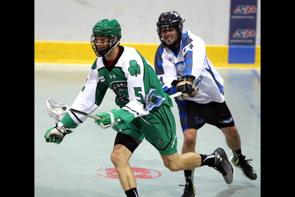 Victoria Shamrocks&Otilde; Tyler Hass is checked by Langley Thunder&Otilde;s Patrick Saunders during the first period on Friday.