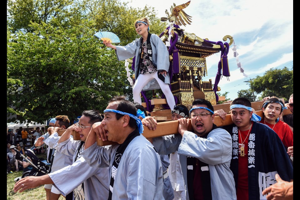 Nana Tamura of Vancouver Rakuichi stands on top of the omikoshi during the 39th annual Powell Street Festival that took place at Oppoenheimer Park this past weekend. The festival celebrates Japanese Canadian arts, culture, and heritage. Photograph by: Rebecca Blissett