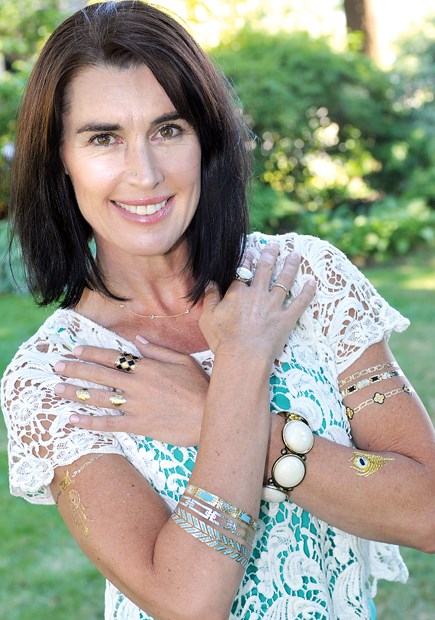 Paula Lamb, owner of Tidytatts, sports a few of her temporary metallic tattoos. The jewelry-inspired body art lasts four to six days.