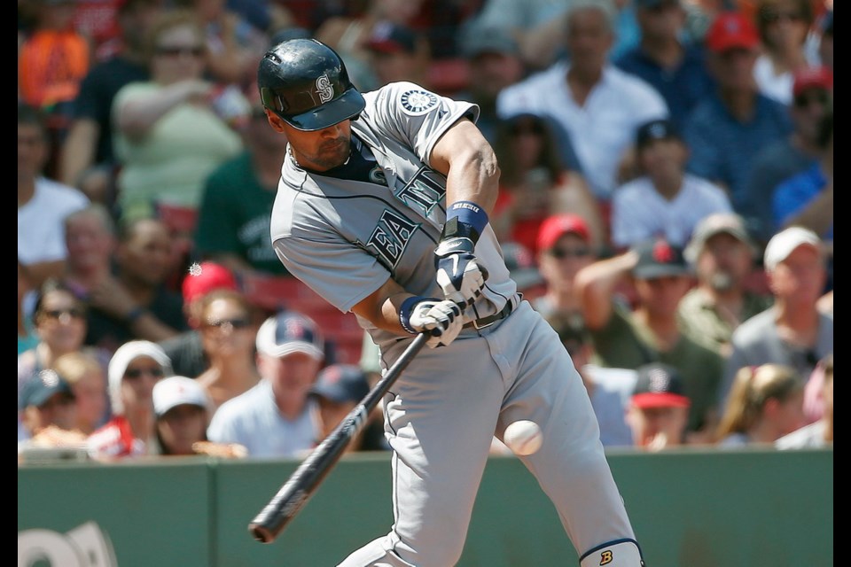 Seattle Mariners' Franklin Gutierrez hits a three-run home run during the third inning of a baseball game against the Boston Red Sox in Boston on Sunday.