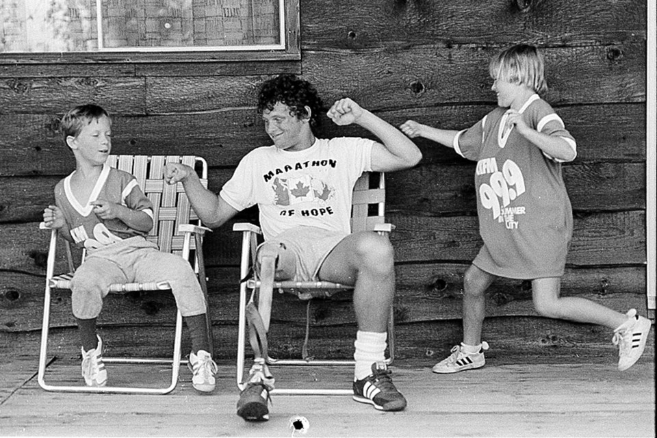 A MOMENT THAT CHANGED HER LIFE: It was 1980, and Kerry Anne Holloway’s dad was the publicity agent for the Canadian Cancer Society. Part of his job was to accompany Terry Fox on his Marathon of Hope across Canada. For two months Kerry Anne and her brother accompanied Fox and his crew during the historical run. Thirty-five years later the Burnaby woman still thinks about the experience every day. At left, Terry Fox, centre, takes it like a champion from Kerry Anne, right, and her brother, Patrick, at left, on a stop during the Marathon of Hope.