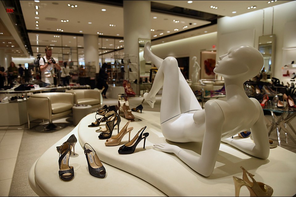 During a media preview of the new Nordstrom luxury retail store in downtown Thursday morning, staff members were busy putting the finishing touches on displays and stocking merchandise. The store opens to the public Sept. 18. Photo Dan Toulgoet