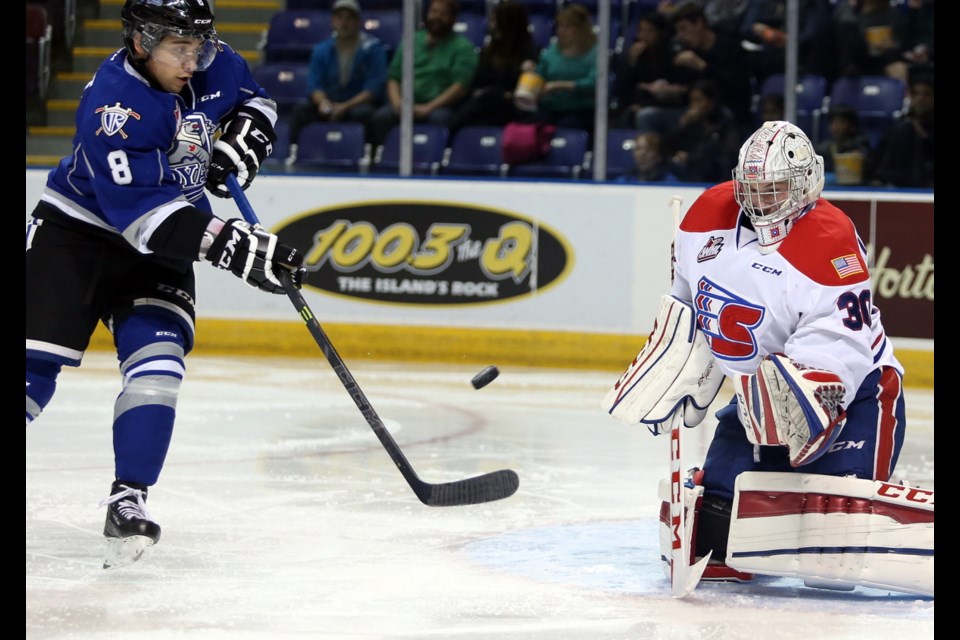 Victoria Royals Ethan Price deflects the puck past Spokane Chiefs goalie Garret Hughson during Wednesday's game at Save-on-Foods Memorial Centre.