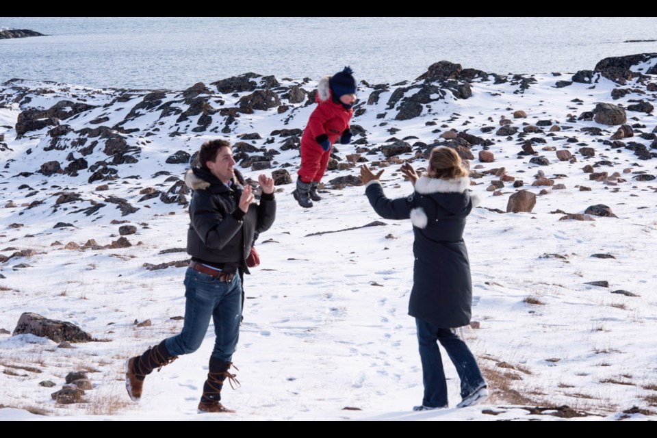 Liberal leader Justin Trudeau throws his son Hadrien into the arms of his mother Sophie while on the shores of Frobisher Bay Saturday, October 10, 2015 in Iqaluit.