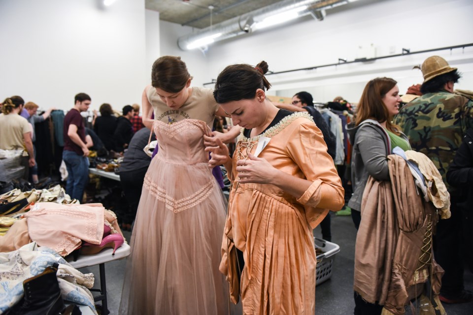 The Bard on the Beach Society held its second annual costume sale this past weekend at its new Southeast False Creek location. Saturday morning’s line-up to get into the sale wound around the building and down West 1st Avenue. Photograph by: Rebecca Blissett