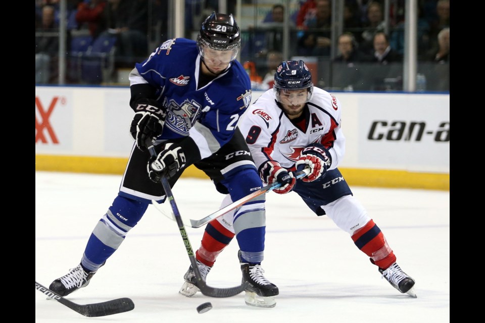 Lethbridge Hurricanes Giorgio Estephan hooks Victoria Royals Logan Fisher during the first period of Tuesday's game at Save-on-Foods Memorial Centre.