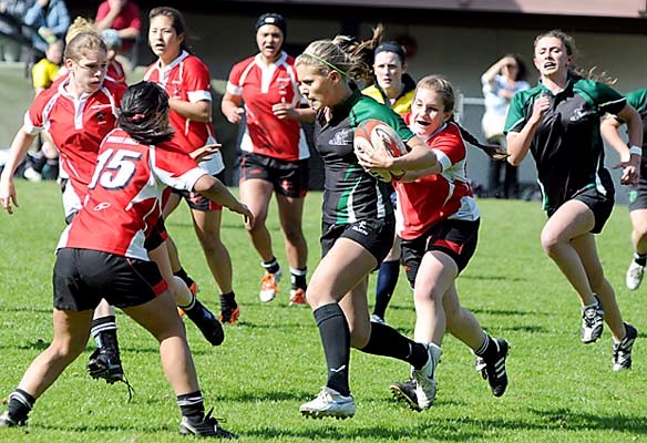 Carson Graham (red) in action against Walnut Grove in the first day of competition in the 2012 B.C. Provincial Girls Rugby Championships held at Klahanie Park.