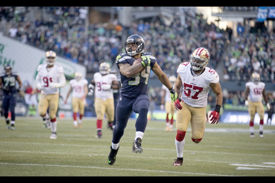 Seattle Seahawks running back Thomas Rawls looks back as he heads for the end zone for a touchdown during the fourth quarter of Sunday's game at CenturyLink Field in Seattle.