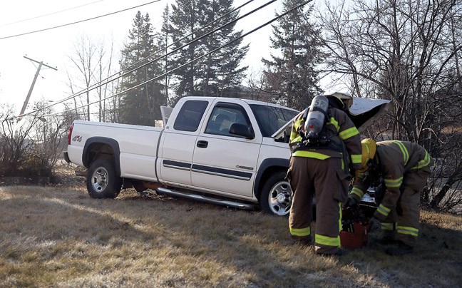 Emergency crews attend to a vehicle that crashed on Queensway Thursday afternoon.