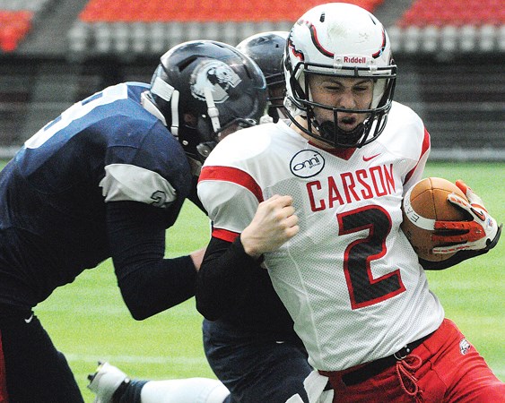 Carson Graham quarterback Tyler Nylander muscles past a pair of defenders during a 24-21 win over G.W. Graham in the provincial AA semifinals. photo by Cindy Goodman, North Shore News