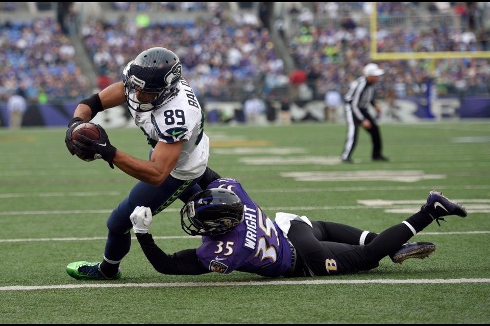 Seattle Seahawks wide receiver Doug Baldwin (89) scores a touchdown as he is tackled by Baltimore Ravens defensive back Shareece Wright (35) during the first half of Sunday's NFL football game in Baltimore.