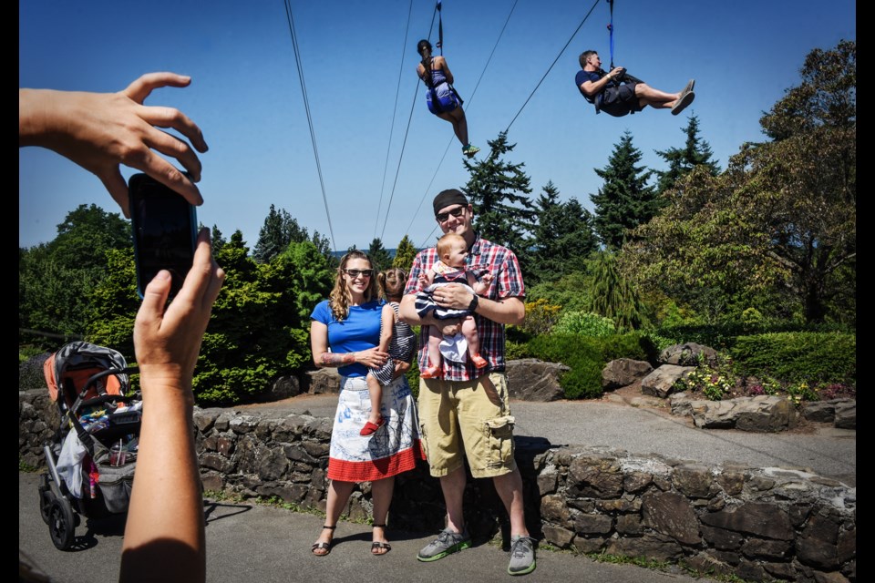 First-time visitors to Queen Elizabeth Park Karen and Nate Whistler with daughters Hazel and Fiona, wanted a family photograph taken in front of the park’s temporary zipline.