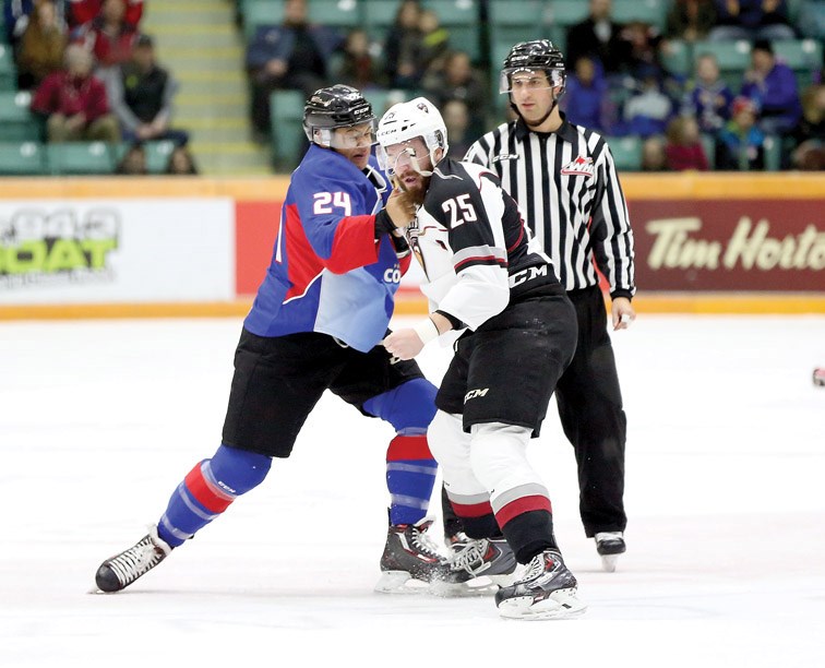 Kolby Johnson of the Prince George Cougars lands a punch to the face of Vancouver Giants Taylor Crunk during a 1st period fight on Sunday at CN Centre. The Giants were in town on Sunday to face the Cougars in the 2nd game of a weekend doubleheader. Citizen Photo by James Doyle January 3, 2016