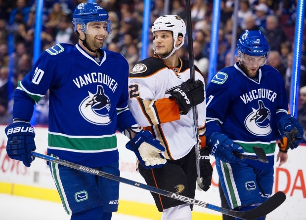 Chris Higgins and Yannick Weber laugh it up with Kevin Bieksa