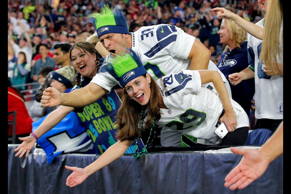 Seattle Seahawks fans cheer during the first half of Sunday's game against the Arizona Cardinals in Glendale, Ariz.