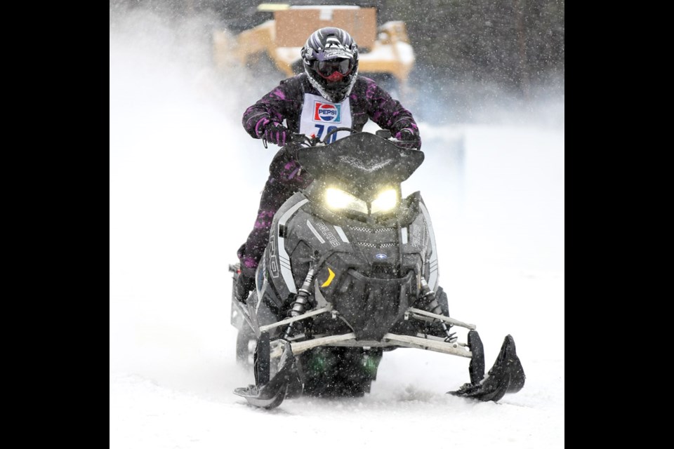 Carla Anderson hits the throttle on her sled during the snowmobile drag races held at NITRO Motorsports Park on Sunday. Racers of all ages and skill levels competed on stock, and modified snowmobiles, as well as, snowbikes. Citizen Photo by James Doyle February 7, 2016