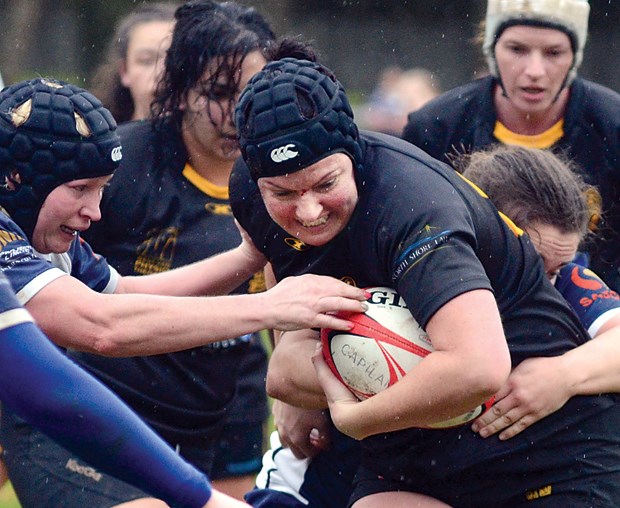 Nathalie Beliveau of the Capilano Rugby Club drags a couple of Burnaby Lake tacklers during a premier women’s matchup Saturday at Klahanie Park. photo by Paul McGrath, North Shore News