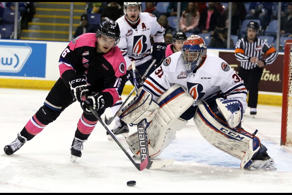 Victoria Royals' Alex Forsberg is steered off the puck by Kamloops Blazers goalie Dylan Ferguson at Save-on-Foods Memorial Centre. Saturday night's game was the Royals' fifth annual Pink in the Rink Night to raise funds for breast cancer research.