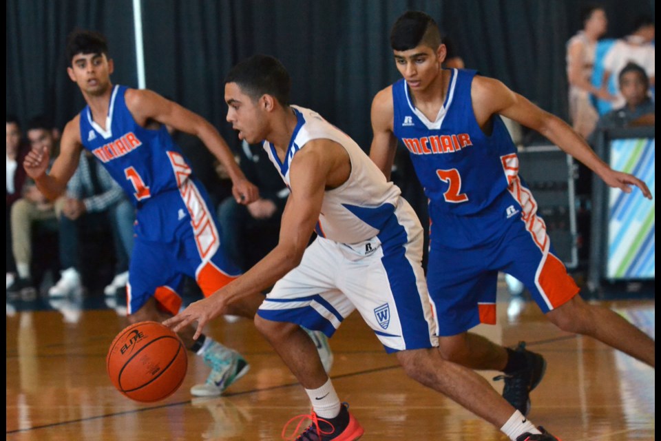 McNair's Jovan Dhillon (1) and Talivinder Jadge apply some defensive pressure during Thursday's Lower Mainland AAA playoff game against Windermere. Both hit some clutch shots in the second half to help their team beat the Vancouver champs and clinch a B.C. berth