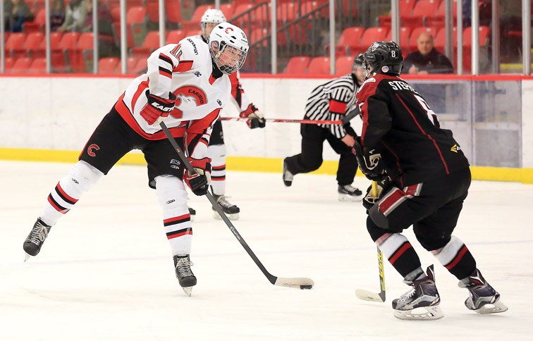 Cariboo Cougars Josh Maser tries to put a shot on goal past Vancouver NW Giants Carter Stephenson on Friday at Kin 1. The Cougars and Giants met in the first game of the best-of-three semifinal series between the two teams. Citizen Photo by James Doyle March 11, 2016