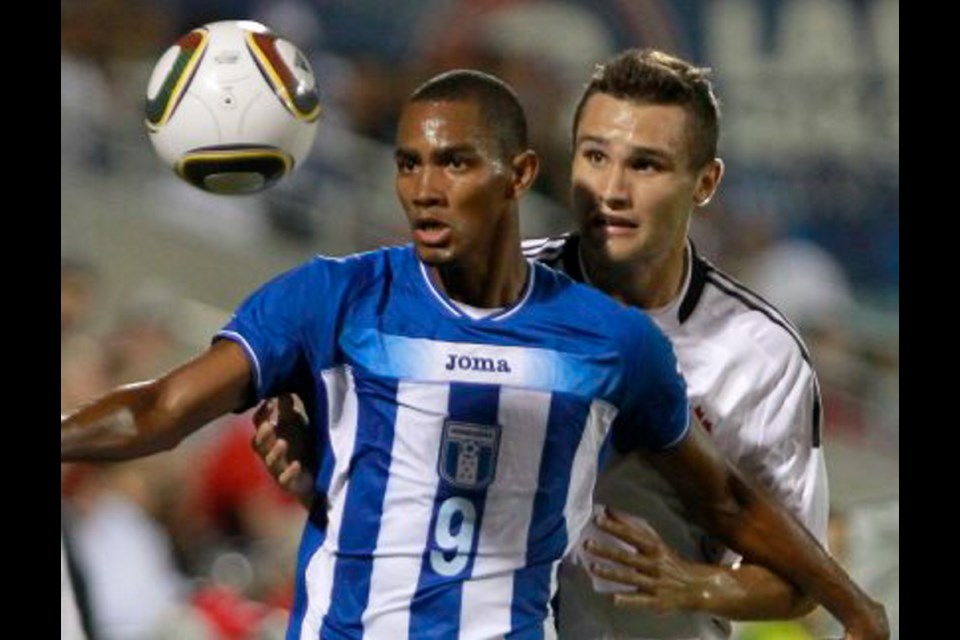 Playing for saʴý, Adam Straith, right, battles Jerry Bengston of Honduras in Montreal in September 2010.