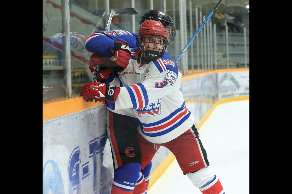 Zachary Minaker of Team White checks Devin Sutton of Team Blue into the boards on Sunday at Rolling Mix Concrete Arena. Team Blue took on Team White in the 2016 Prince George Spruce Kings Top Prospects Game. Citizen Photo by James Doyle April 10, 2016