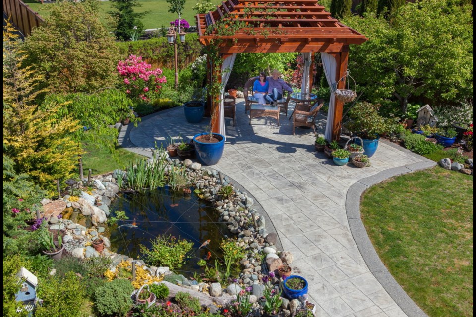 Gail and Roger Anderson sit in the garden of their Mill Springs home, in a pergola that cost Roger "a lot of blood, sweat and tears. &hellip; I saw a picture and thought I could build it, but it was a lot of work because of all the angles, and I had no plans to work from."