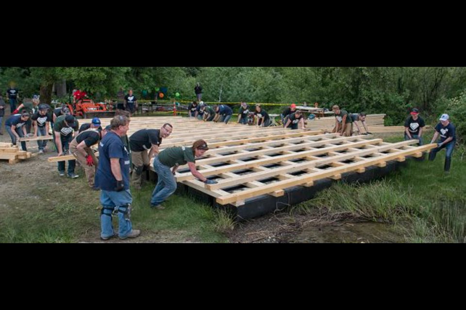 HeroWork volunteers repairing the dock at the George Pringle Memorial Camp near Shawnigan Lake earlier this month. HeroWork&Otilde;s next project: A Rainbow Kitchen renovation.