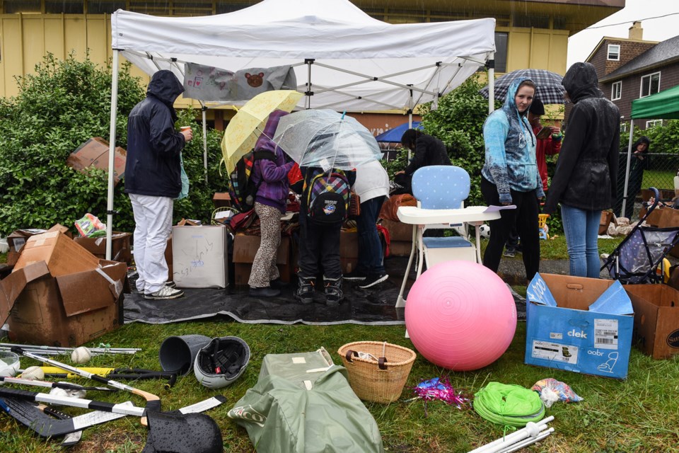 Volunteers braved Saturday’s torrential downpour to run the popular garage sale as part of Cedar Cottage Neighbourhood House’s 23rd annual carnival held Saturday.