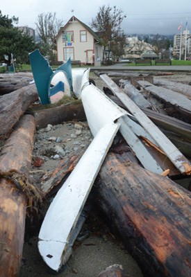A smashed fiberglass kayak lays in pieces amongst the logs washed up on the beach in front of the Ferry Building gallery, Mondays' storm caused all sorts of damage along the West Van waterfront.